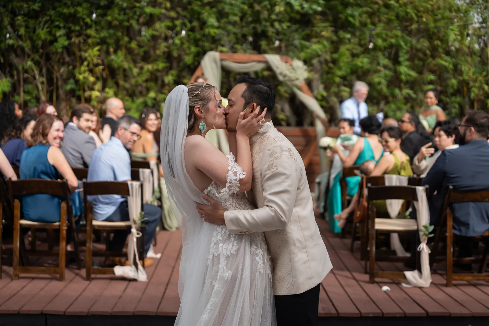 First kiss at outdoor bamboo courtyard ceremony at Brick and Beam