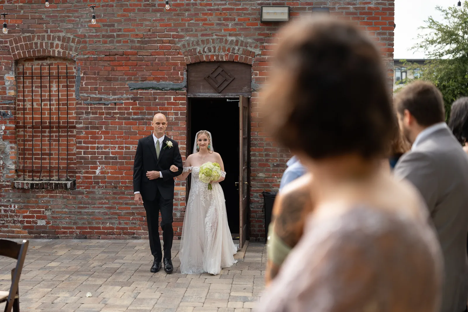 Reception room setup with Edison bulbs and brick walls at Brick and Beam