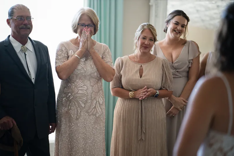 Jake's family members react with joy and emotion as Laurel enters the bridal suite at The White Room.