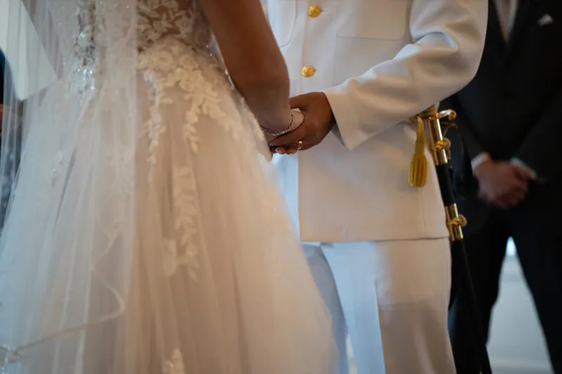 Hands clasp as the couple holds each other during their first moments as a married couple.