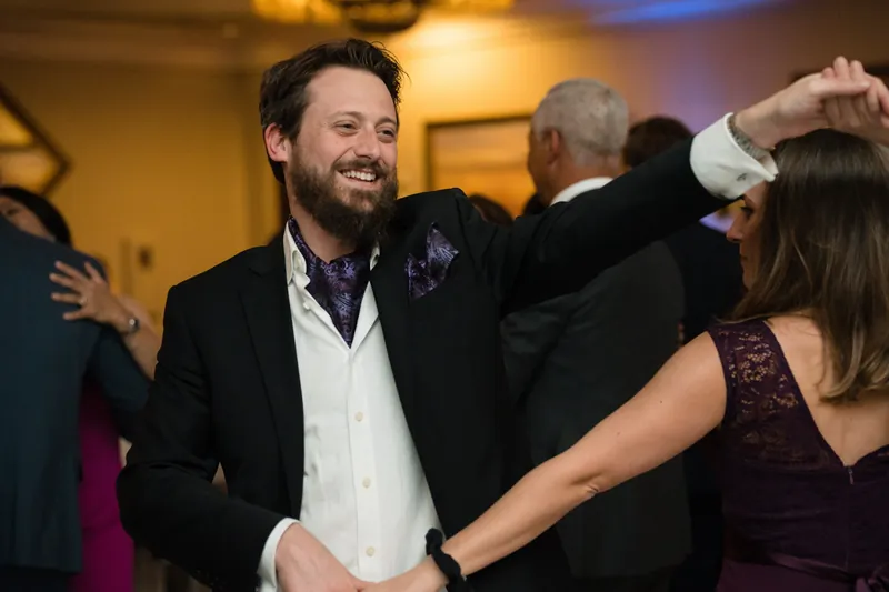 Cole dances and laughs with guests during the reception celebration.