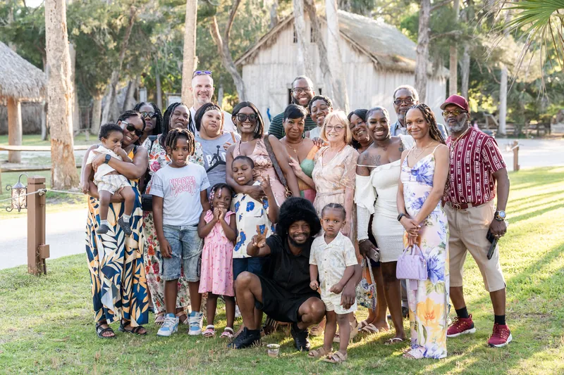 Extended family and children gather in casual dress outside a historic structure at Fountain of Youth Archaeological Park