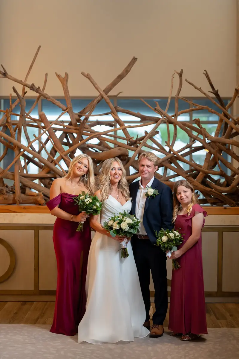 Wedding party portrait with driftwood art backdrop