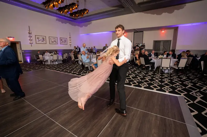 Young guests posing by windows at dusk