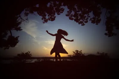 Lydia senior portrait silhouette dancing at sunset at Washington Oaks State Park