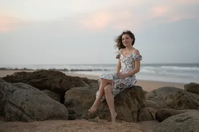 Lydia seated on coquina rocks at beach