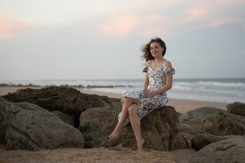 Lydia seated on coquina rocks at beach