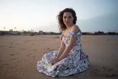 Lydia seated on beach sand portrait