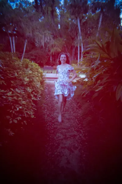 Lydia walking down garden path at Washington Oaks