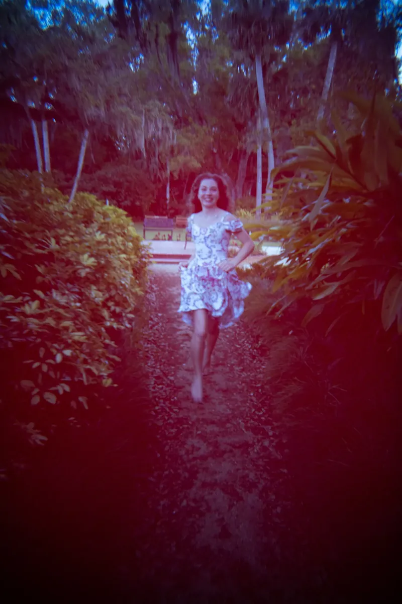 Lydia walking down garden path at Washington Oaks