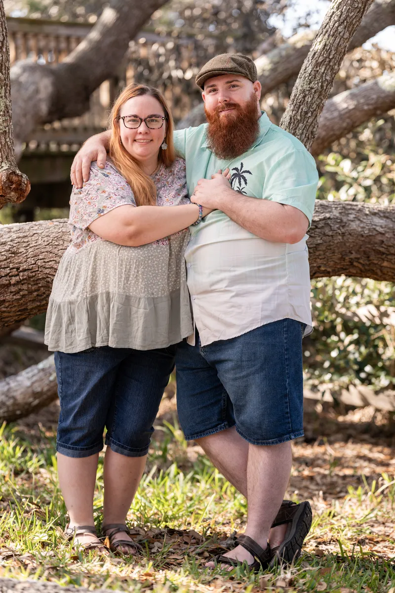 Couple standing together by the oak tree at Nease Park
