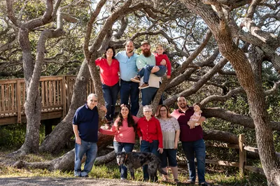 St. Augustine family photographer - four generations gathered around an oak tree at Nease Park