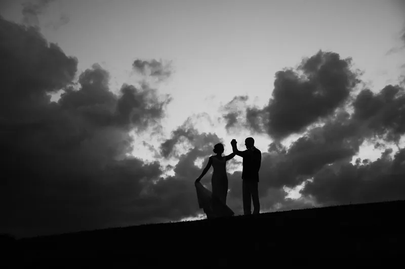 Black and white silhouette of couple spinning