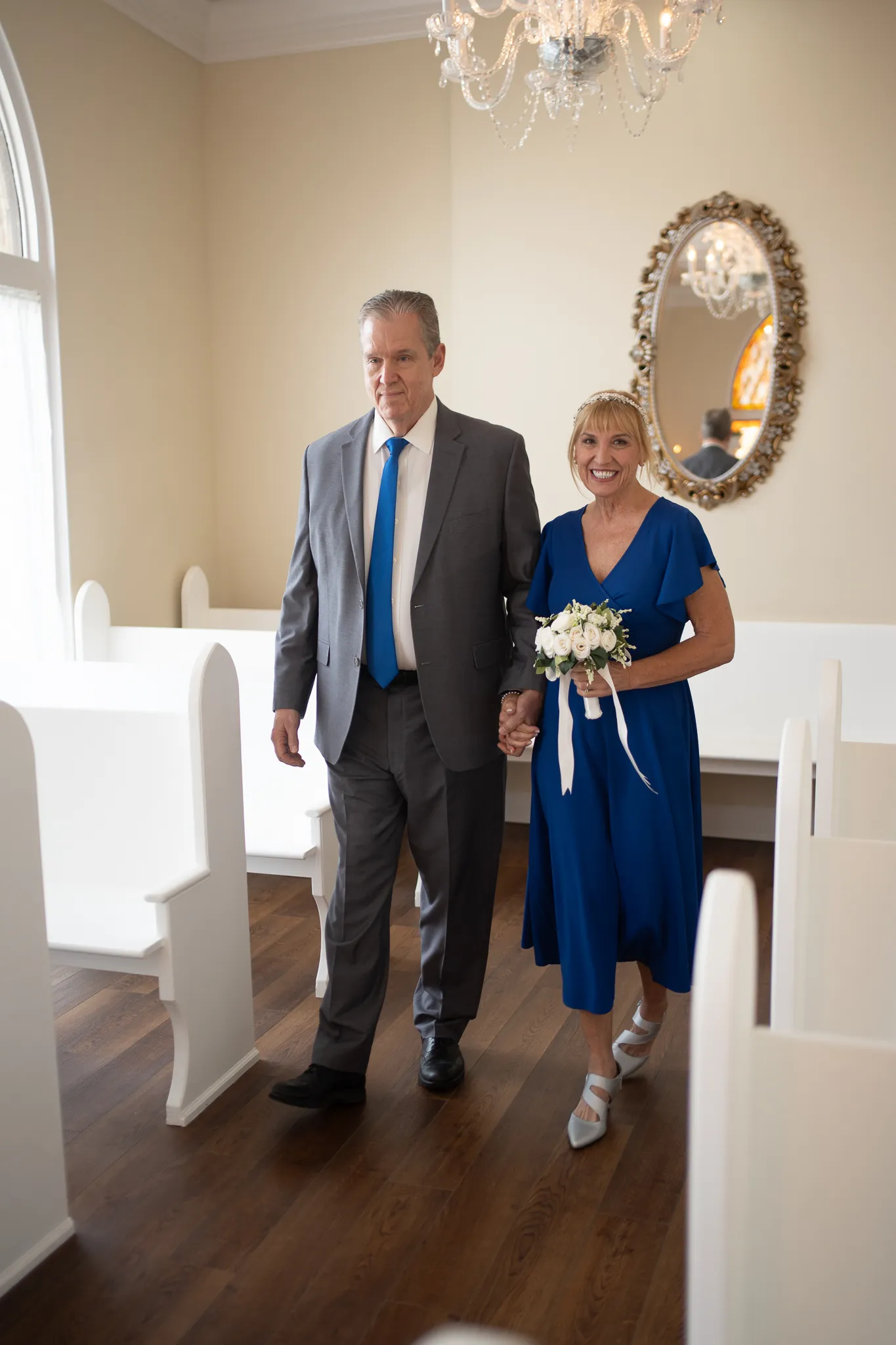 Marlene and Keith walking down the aisle together at Amore Wedding Chapel