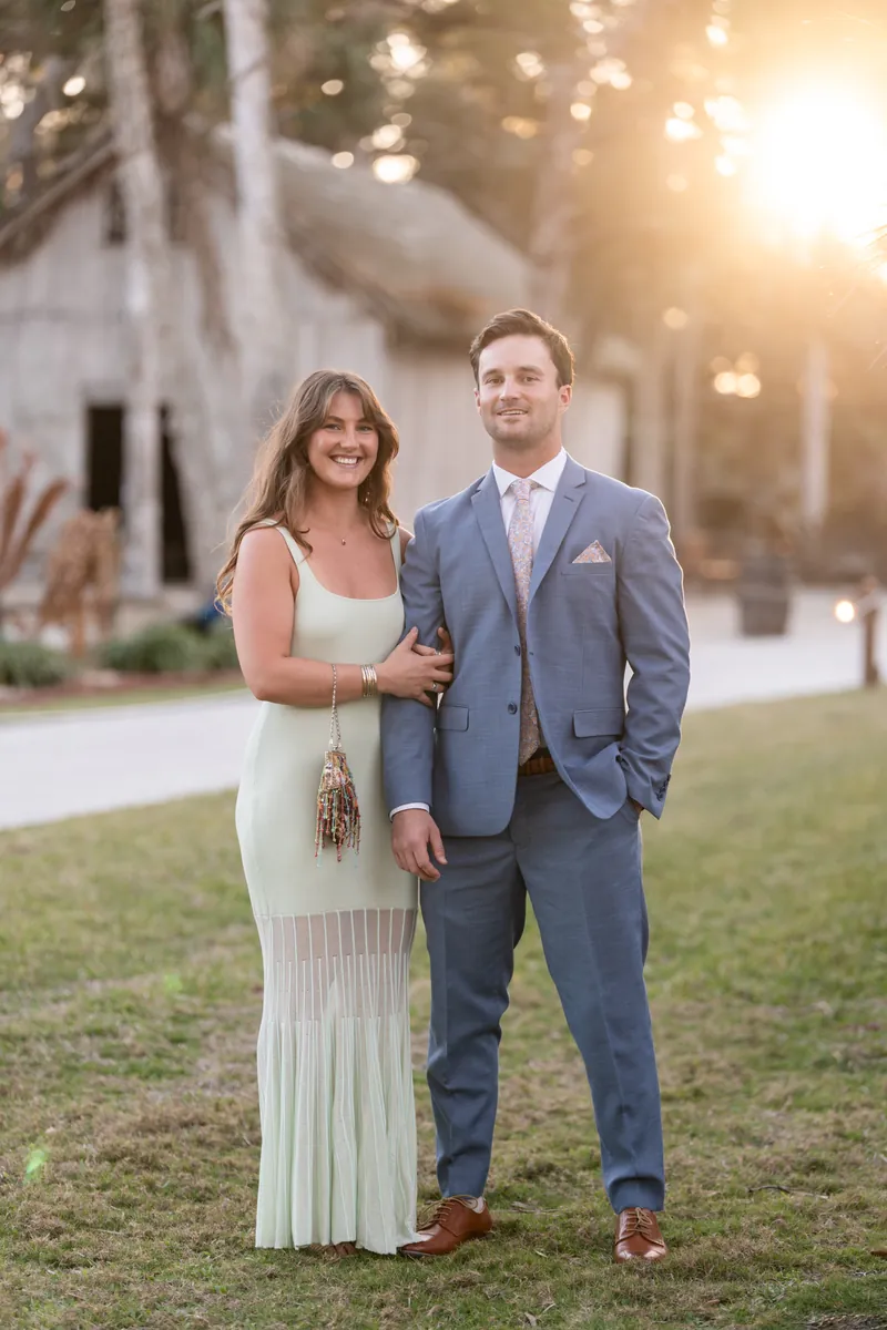 Guest couple portrait at golden hour with Fountain of Youth buildings behind them