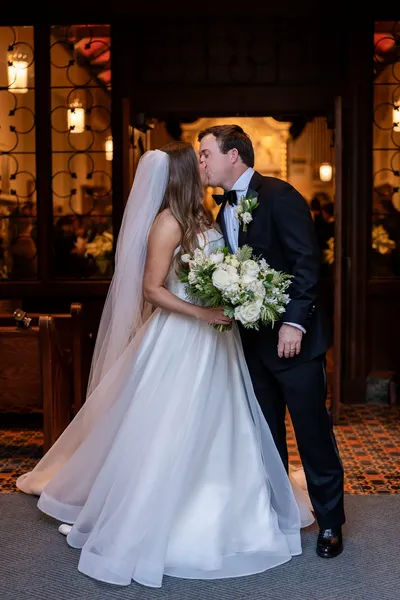 Megan and James share a kiss at the Cathedral Basilica doors after their wedding ceremony