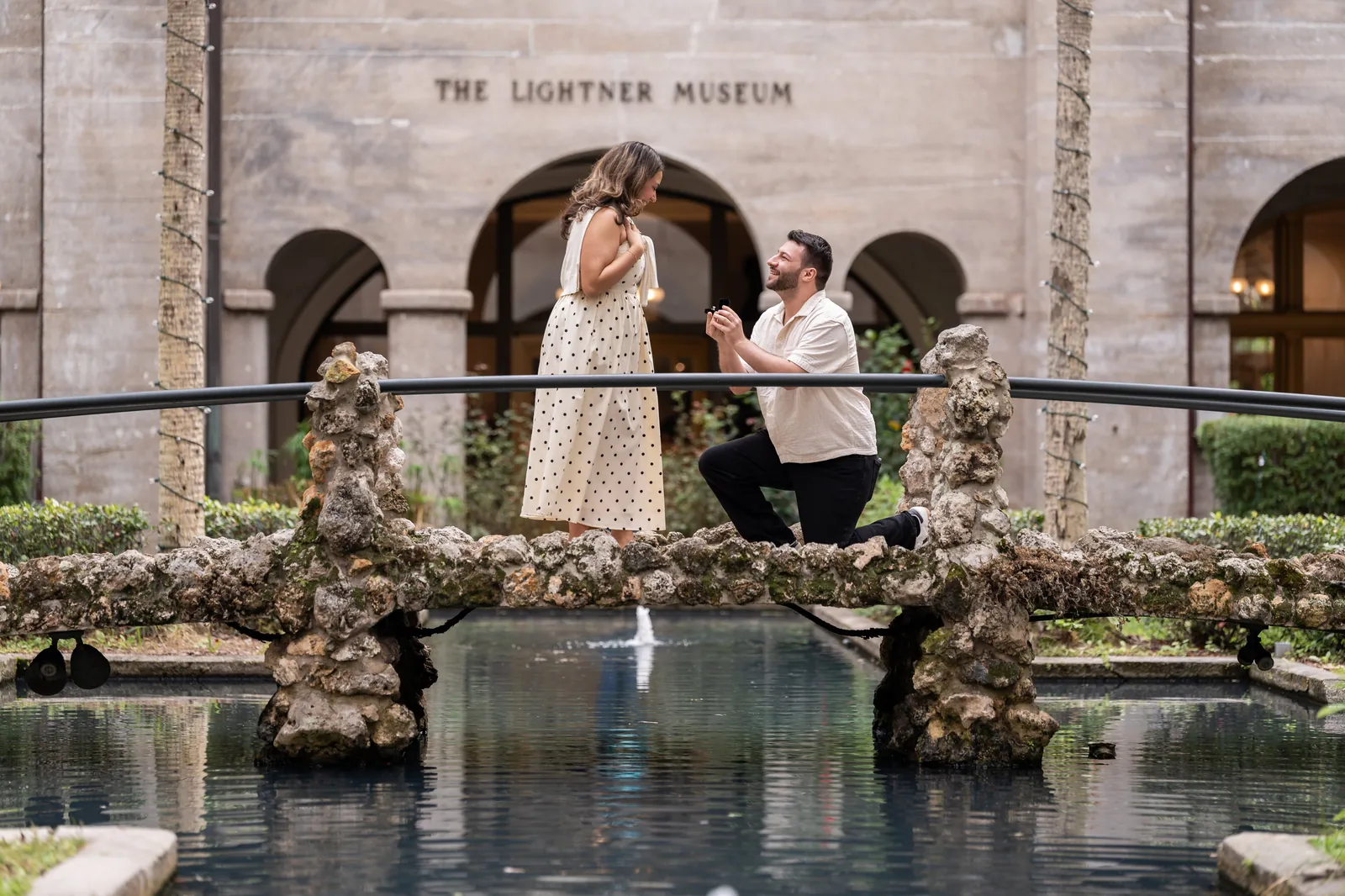 Metodija and Tiffany proposal moment at the Lightner Museum courtyard