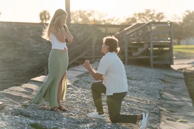 Couple standing in sunny park field, St. Augustine proposal photographer captures romantic moment