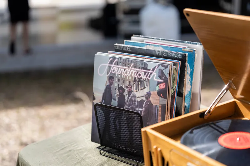 Vinyl record collection with Houndmouth and Billy Joel The Stranger albums next to turntable
