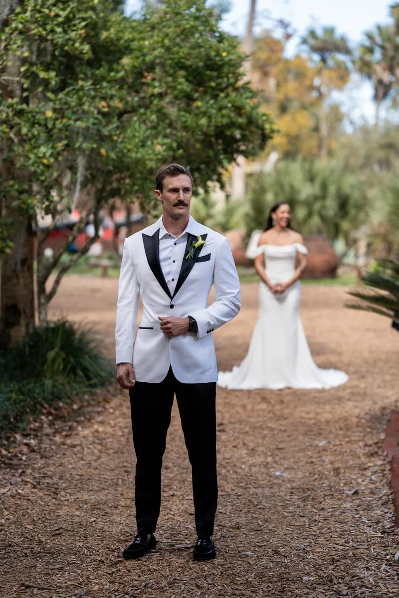 Michelle holding up her hands with tears during first look approach at Fountain of Youth gardens