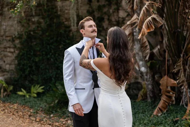 Michelle adjusting Bryants collar near coquina ruins at Fountain of Youth