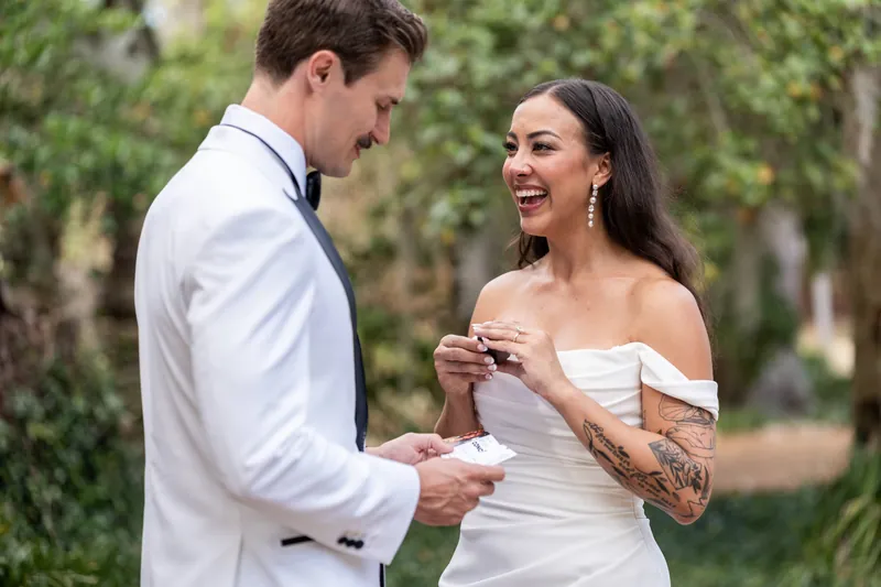Michelle laughing while reading a note from Bryant during private vow exchange