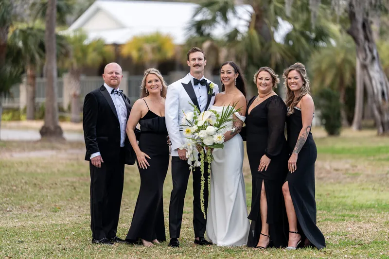 Couple with close family members in group portrait at Fountain of Youth