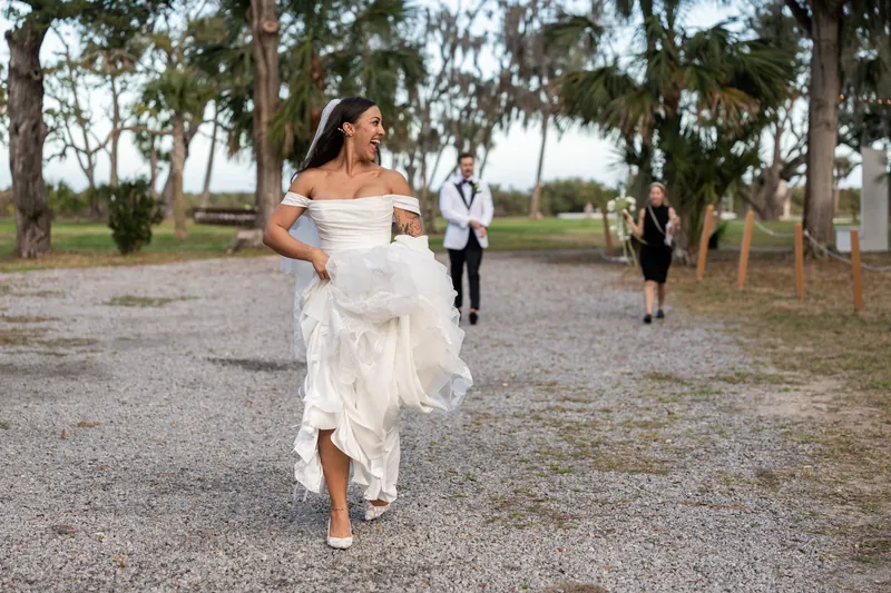 Michelle running excitedly toward the reception with Bryant and coordinator following behind