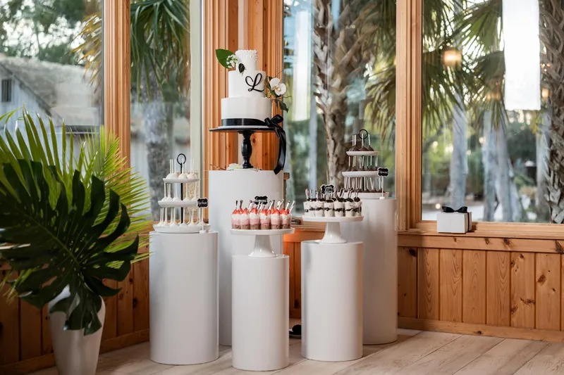 Reception table details with white and green flowers candles and vinyl record table numbers