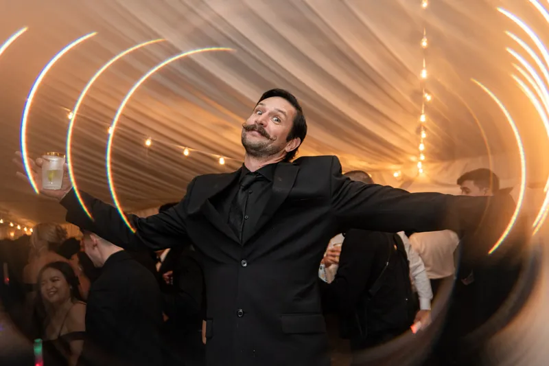 Guest dancing on the dance floor with cocktail and light trail effect