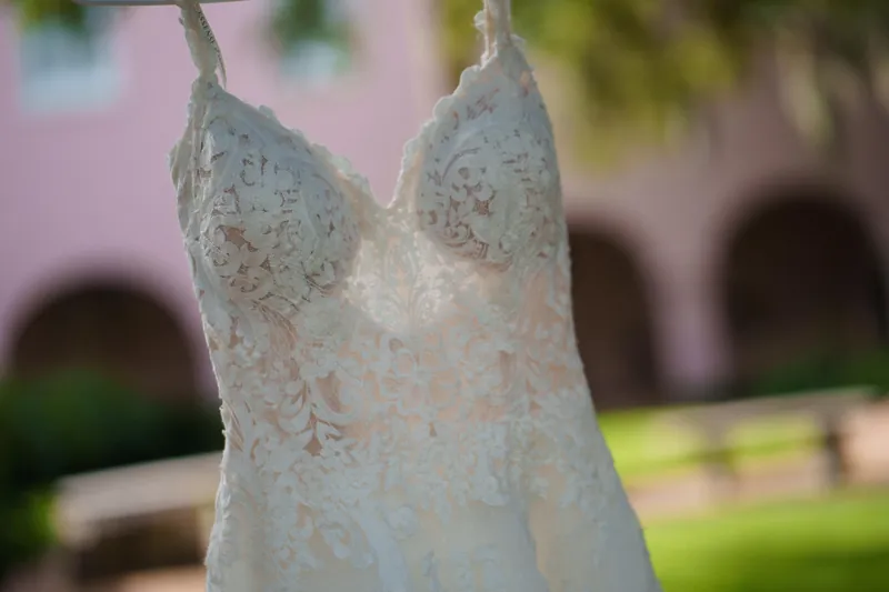 Close-up of Monica's white beaded and embroidered bodice with delicate lace detailing on the wedding gown.