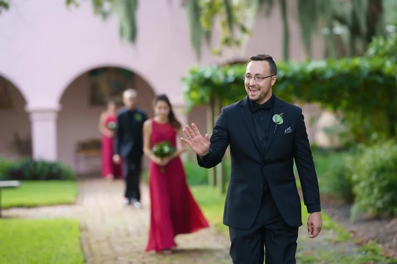 Michael waves with a warm smile as he walks through the courtyard at The Oldest House Museum, St. Augustine.