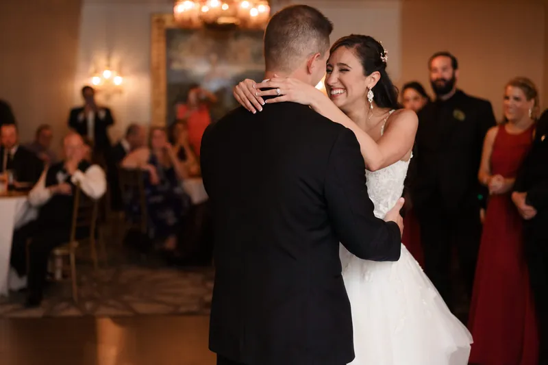 Monica and Michael dance together at Casa Monica Resort & Spa, surrounded by guests in formal attire.