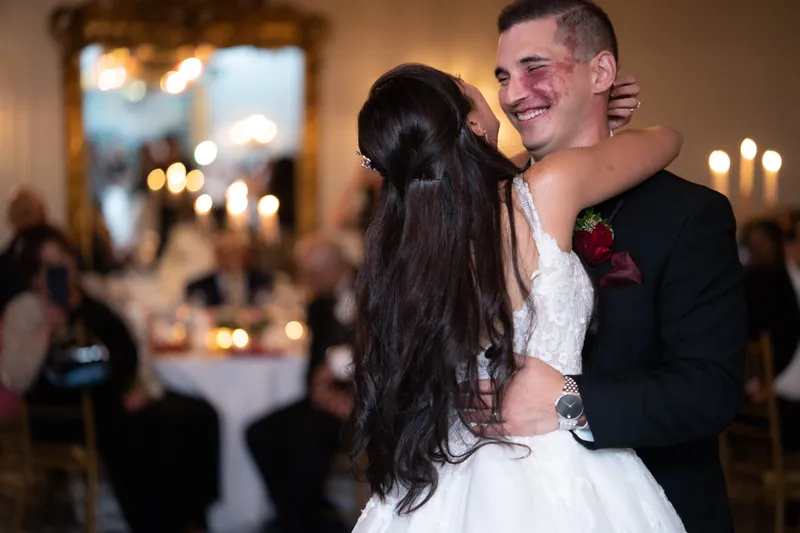 Michael spins Monica during their first dance, her veil flowing as guests watch from the elegant ballroom.