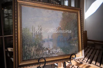 Ornate gold-framed painting with couple name and wedding date displayed