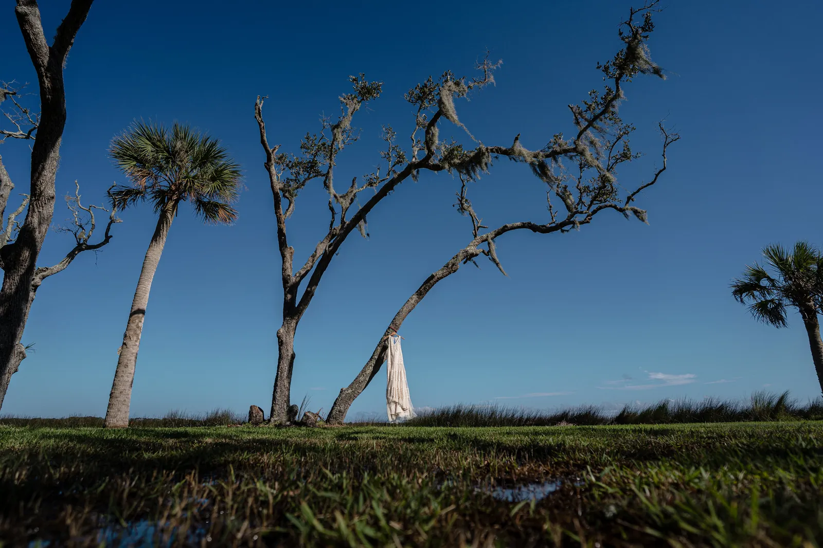 Bride laughing while looking at ring box during getting ready