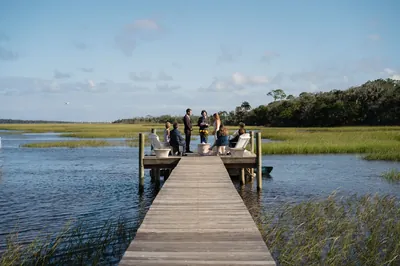 Intimate dock ceremony with family in Adirondack chairs
