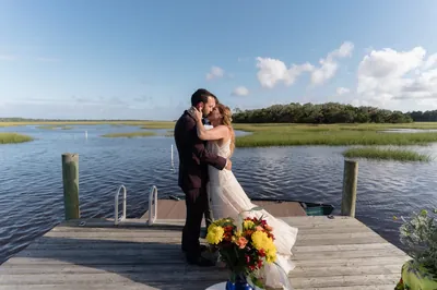 First kiss on the dock with marsh backdrop