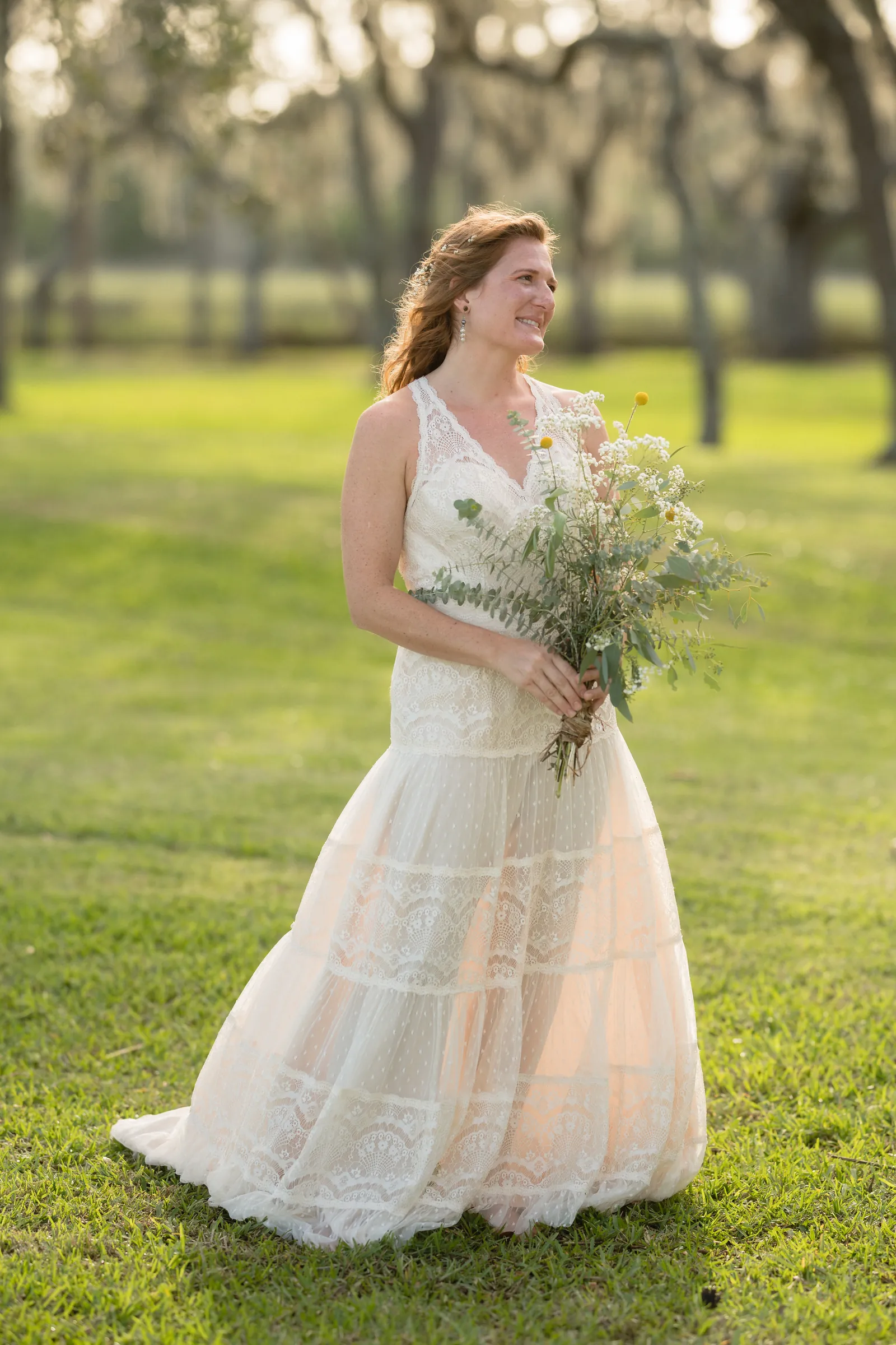 Bride portrait smiling with wildflower bouquet