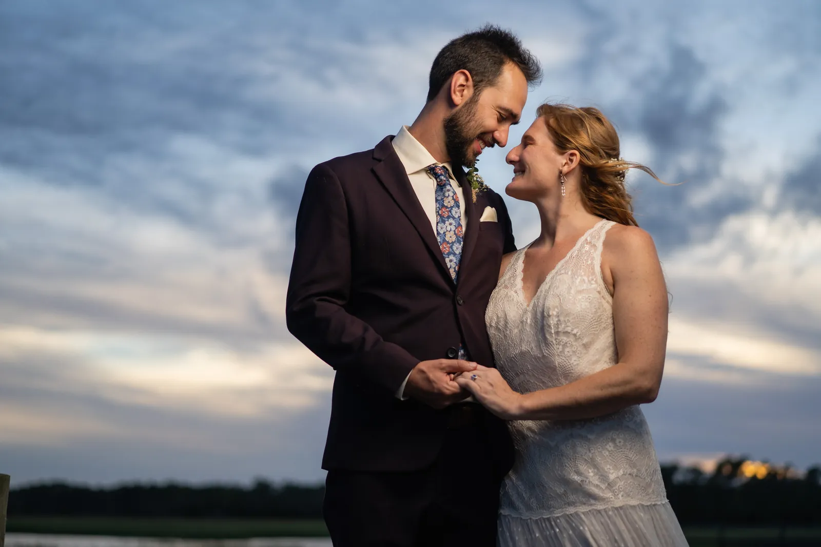 Intimate couple portrait at dusk with dramatic sky