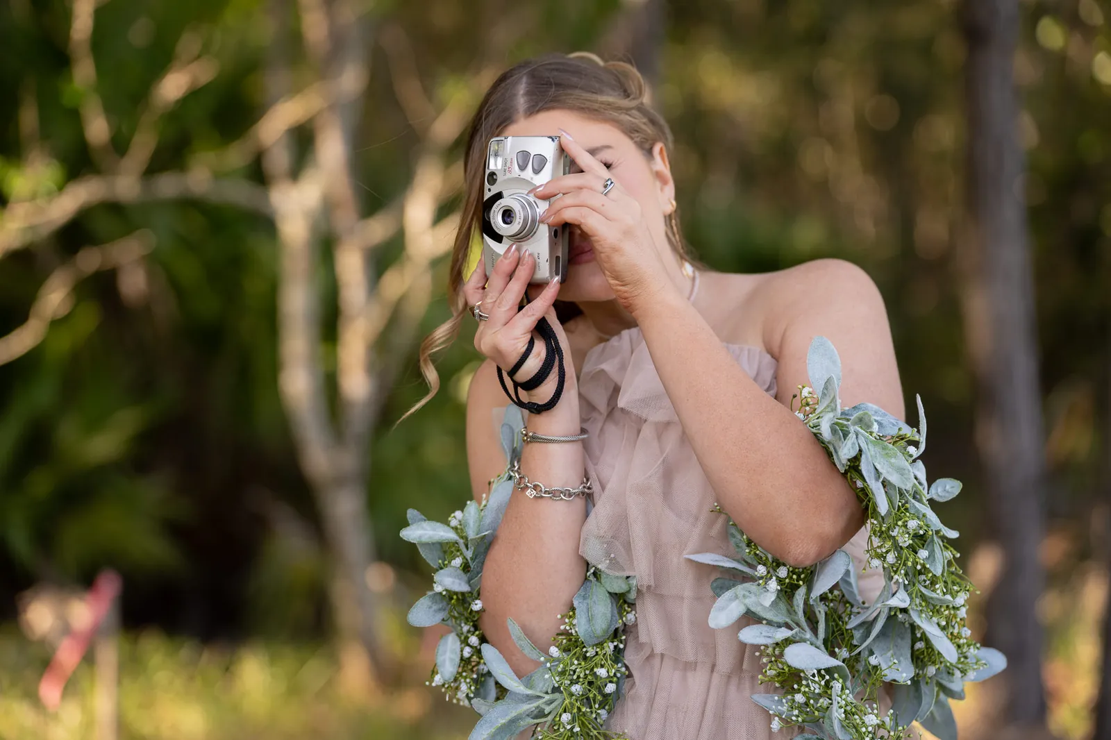 Bridesmaid taking photo with film camera at Tringali Barn wedding