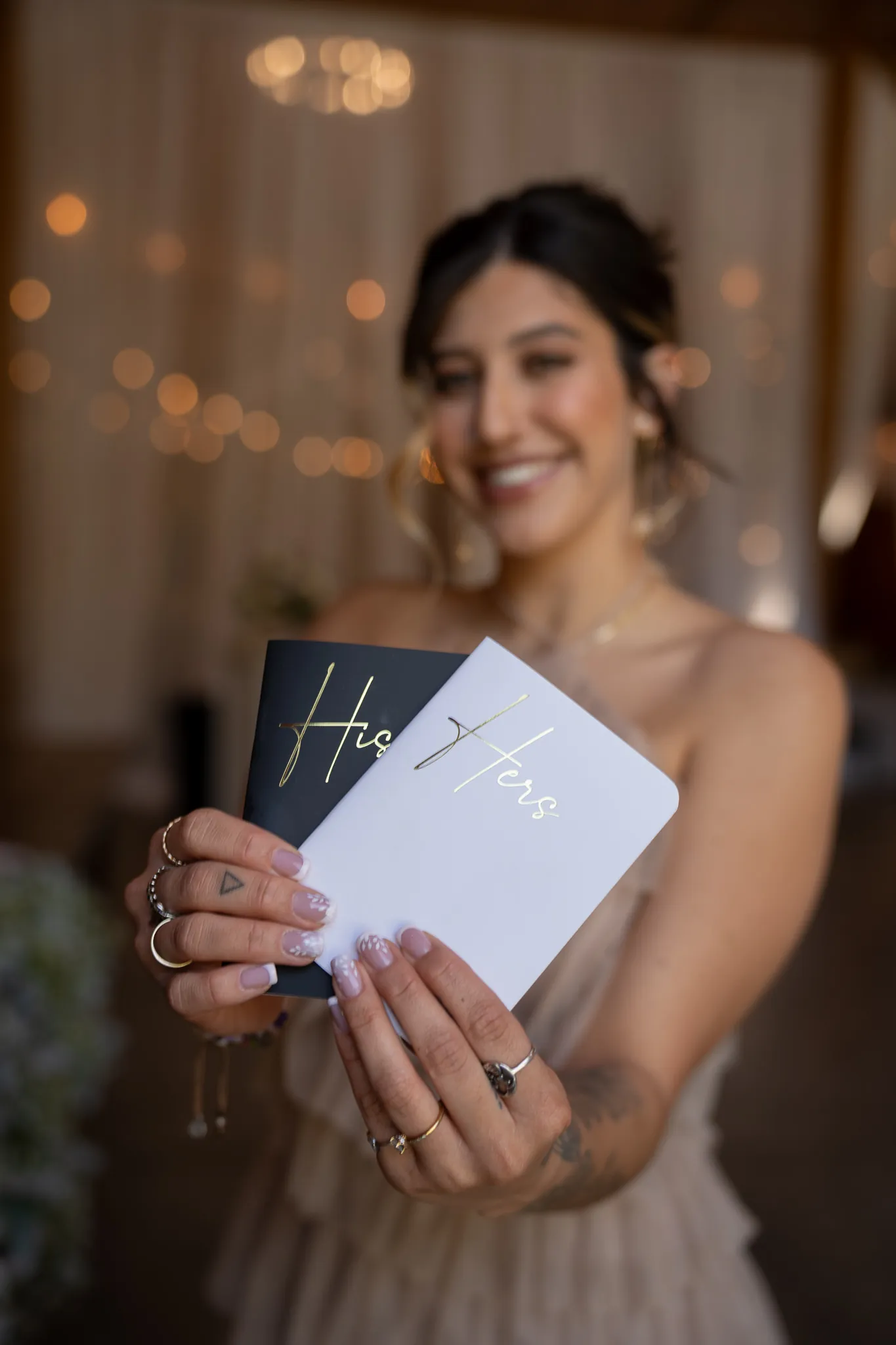 Bridesmaid holding His and Hers vow books at Tringali Barn wedding