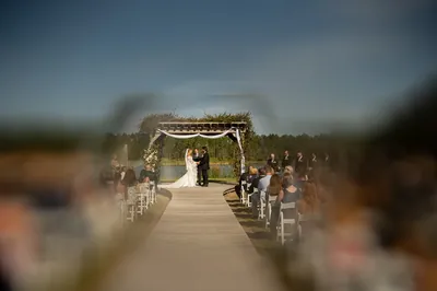Lakeside pergola ceremony at Tringali Barn with guests