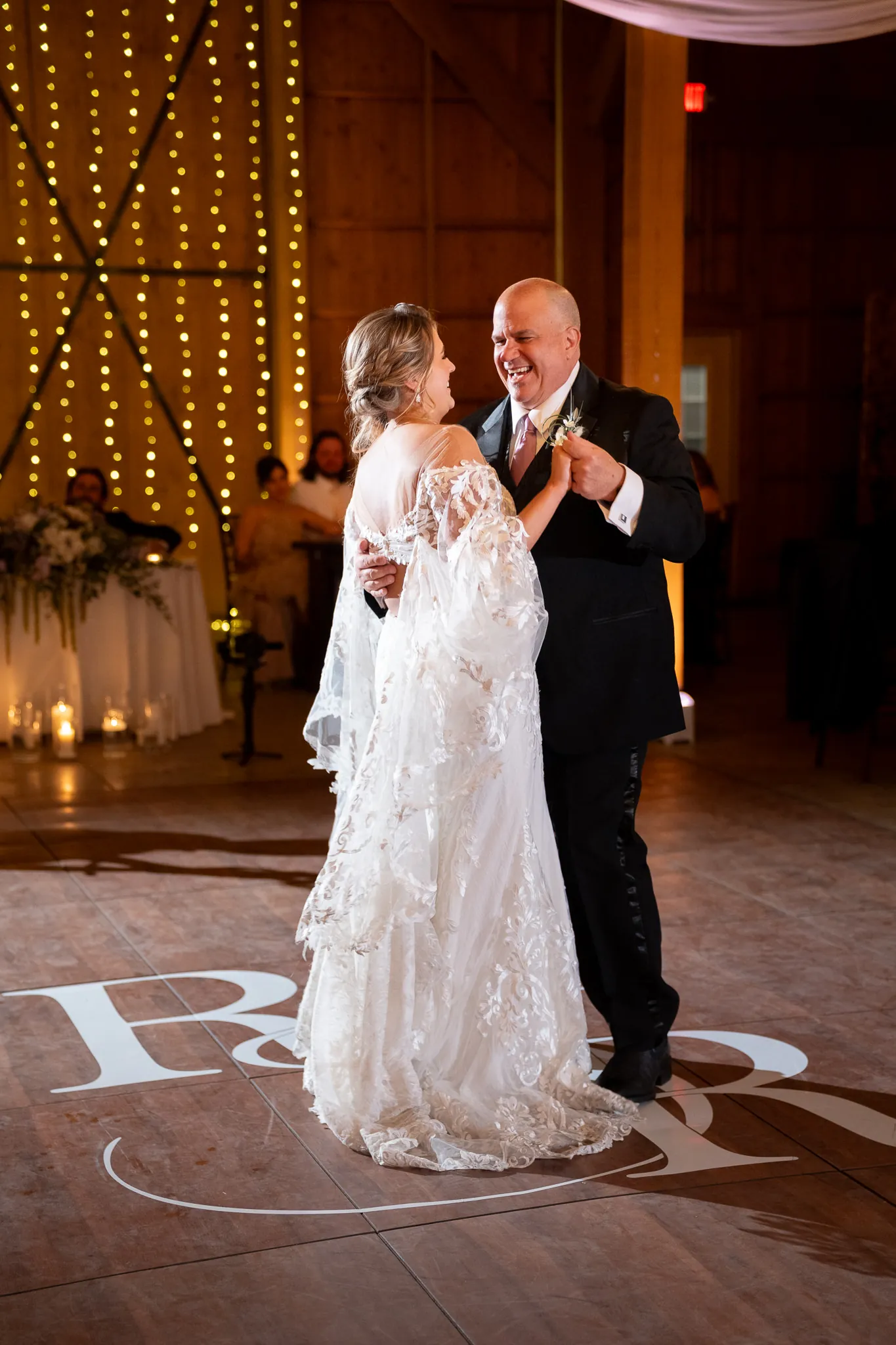 Father daughter dance with monogram on dance floor at Tringali Barn