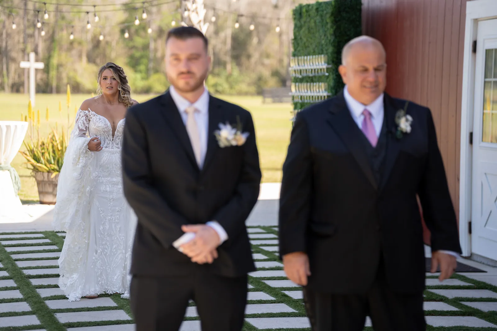 First look bride Riley approaching groom Robert at Tringali Barn