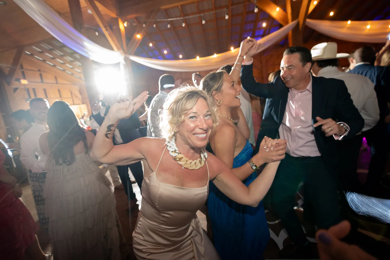 Wedding guests dancing at reception party at Tringali Barn