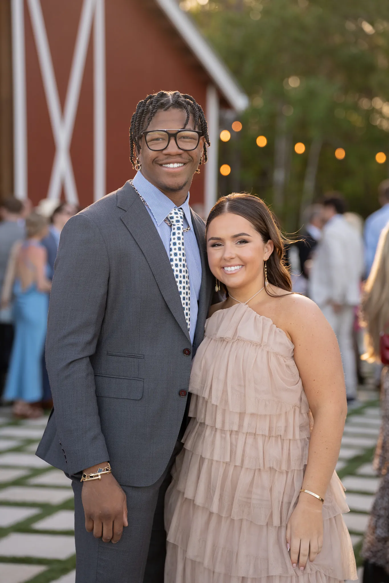 Wedding guests portrait in front of red barn at Tringali Barn