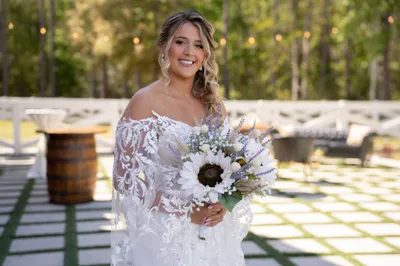 Bridesmaids with bride in front of iconic red barn at Tringali Barn