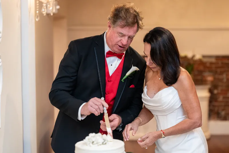 Bill and Rose Ann cut their wedding cake together at The White Room celebration.