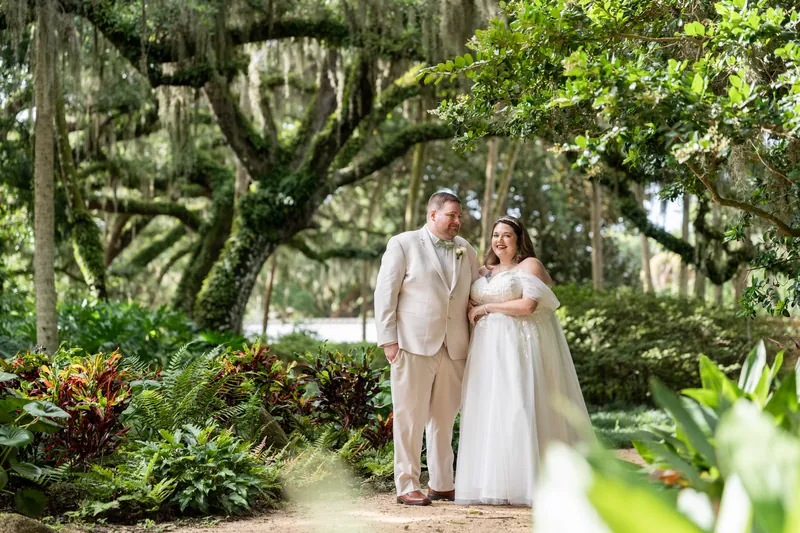 Samantha and Matthew walk a garden path under Spanish moss and dense canopy at Washington Oaks Gardens.